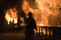 Fireman approaches burning building