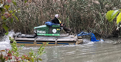 Phrag Control Truxor machine at work in the water