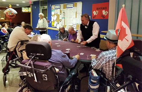 Volunteer dealing blackjack cards to residents