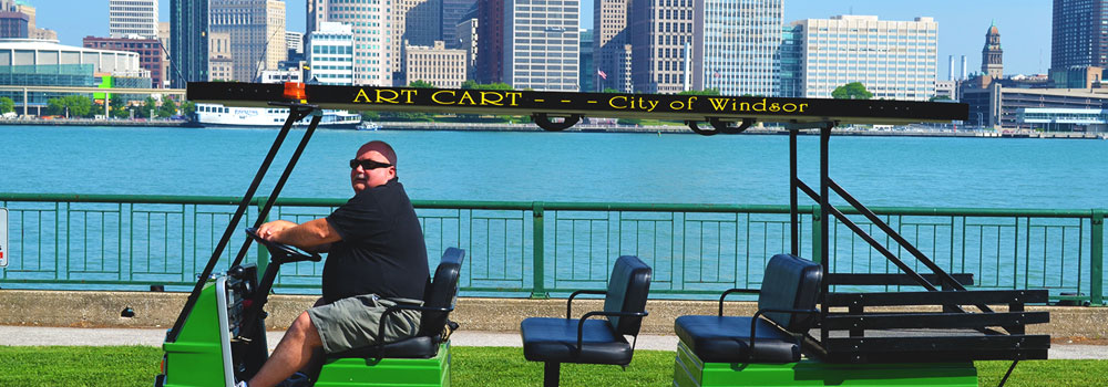 Art Cart driver drving the Art Cart along Windsor's riverfront