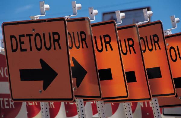 Rows of detour signs and do-not-enter signs