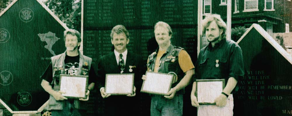 Ed Johnson, Mayor Hurst, Rick Gidner, and Chris Reynolds in front of the Memorial