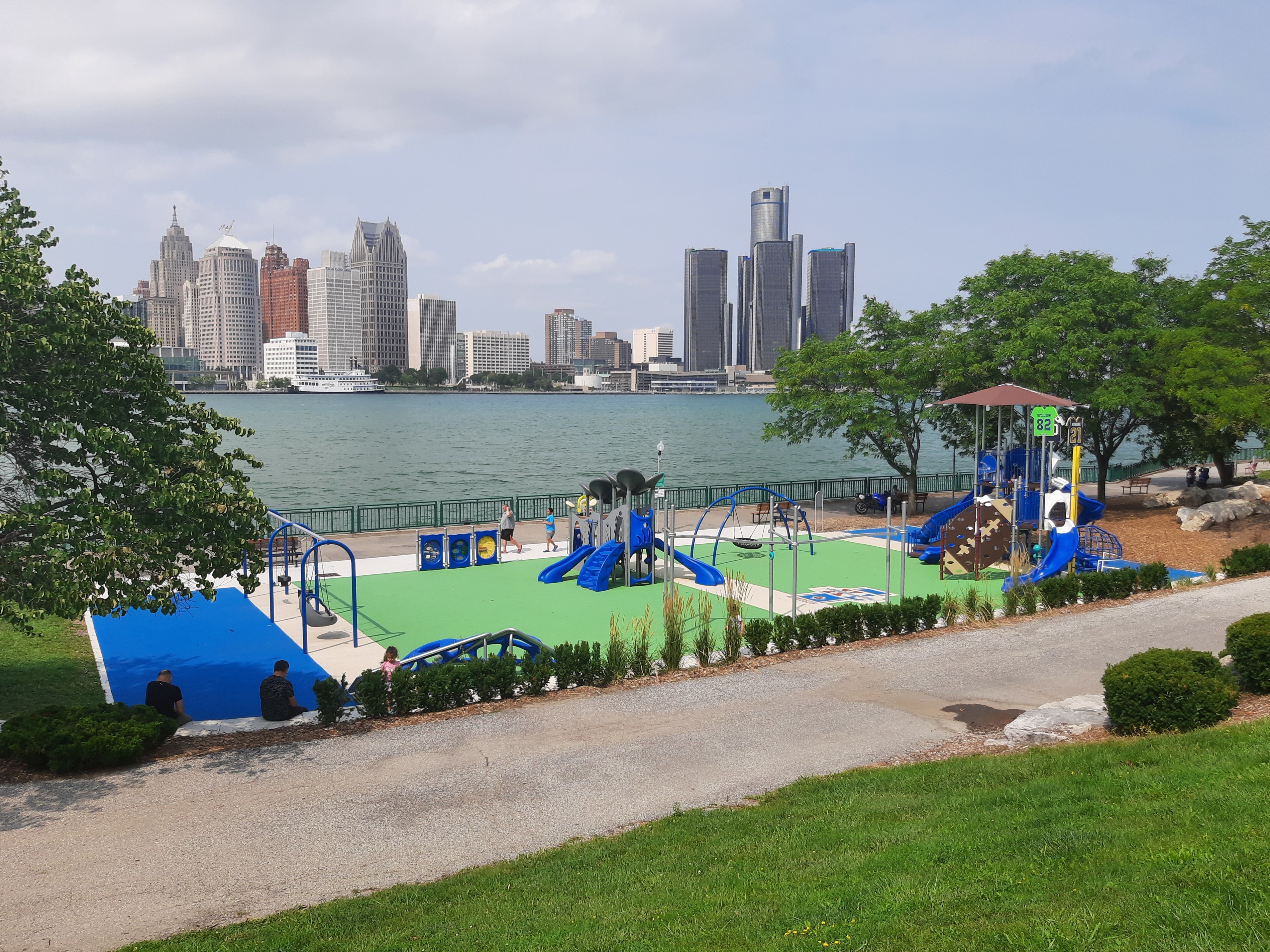 Legacy Park playground on the riverfront with Detroit skyline in background