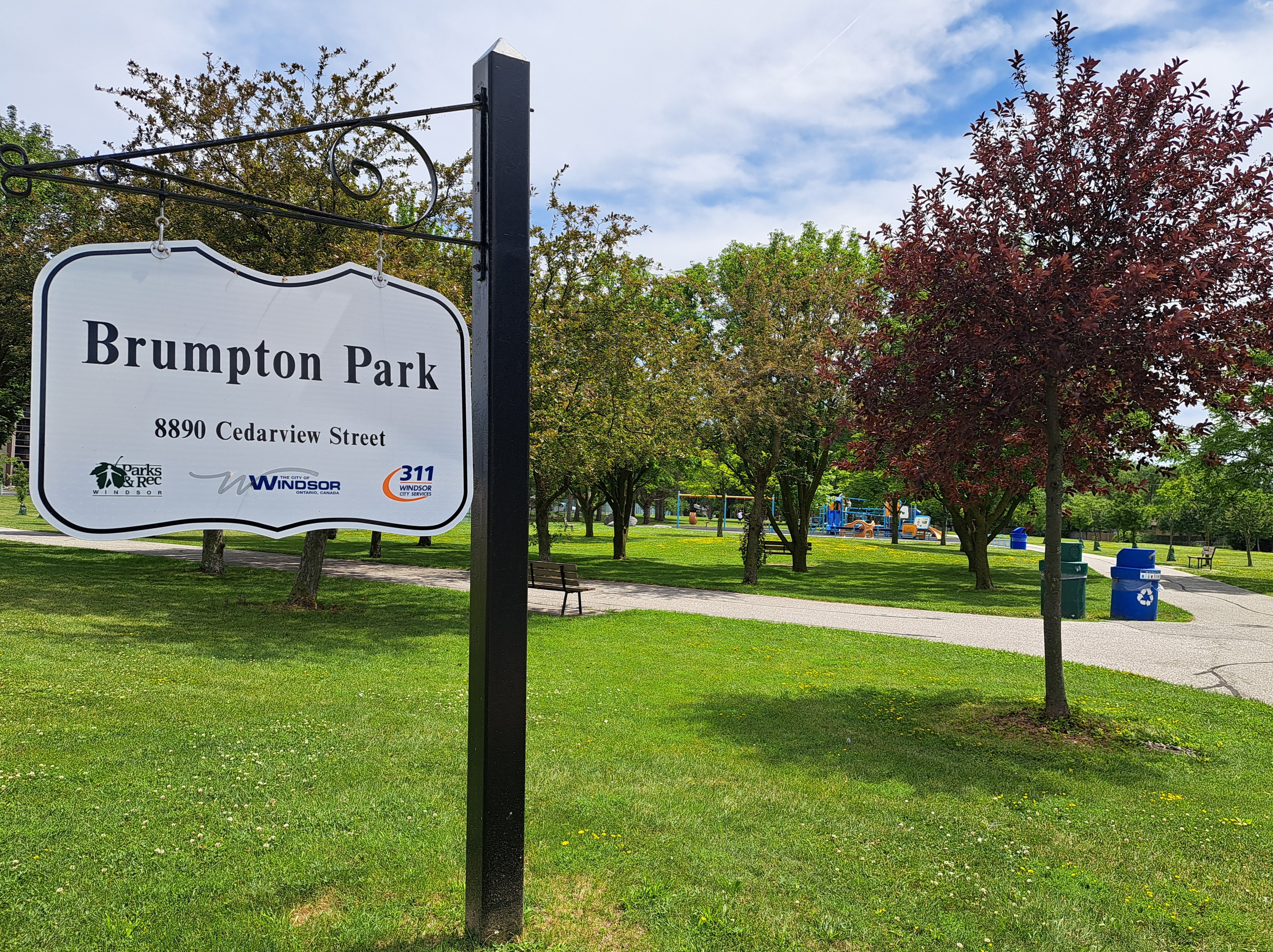 Brumpton Park Brumpton Park sign and trees on green grass