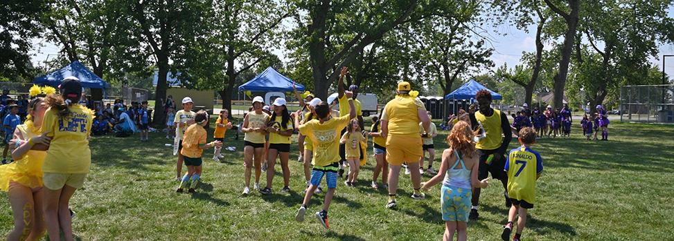 Outdoor recreation activity celebration Team of kids celebrating and being congratulated by the supervisor team at an outdoor activity