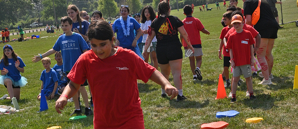 Outdoor team race in a park Two teams of kids cheering on an outdoor race
