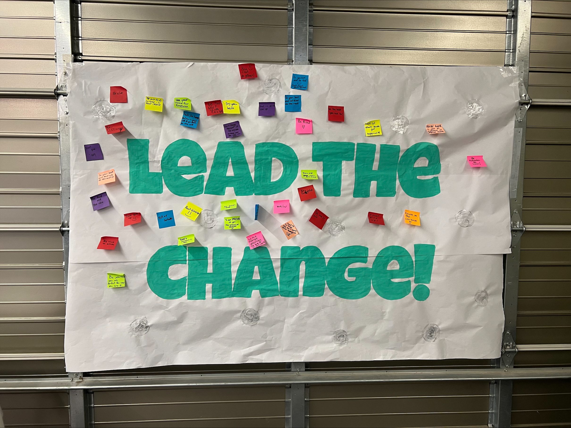 A mural that says Lead the Change!