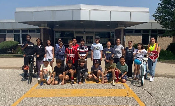 Group photo of students, a teacher, a crossing guard and a representative of Windsor Police Service at Bellewood Public School